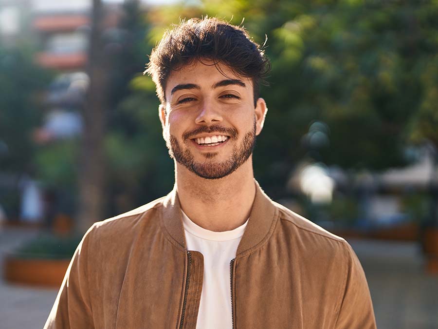 Young,Hispanic,Man,Smiling,Confident,Standing,At,Park